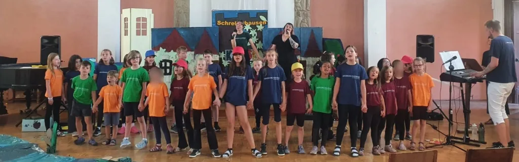 Kinder halten sich an den Händen und singen